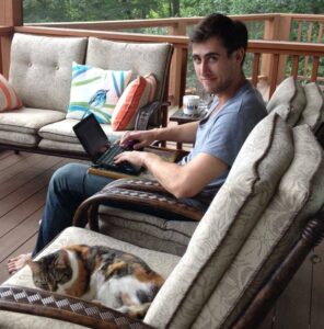 ross denyer writing with cat